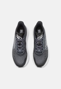 Des chaussures de course grises avec une tige en mesh, un motif texturé, une semelle blanche et un logo HOKA. Présentent un design de laçage complexe et un collier rembourré.
