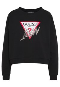 Felpa cropped nera a maniche lunghe con un triangolo logo Guess rosso e bianco e la scritta "Icon" in strass sul davanti.