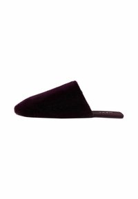 Faux fur slide slipper in deep purple with a pointed, asymmetrical upper. Flat sole with subtle branding on the insole. Soft texture.