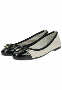 Black and beige ballet flats with a patent toe cap, fabric bow, and gold charm. Features a black elastic trim and flat sole for comfort.