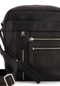 Sort læder crossbody taske med flere lynlåslommer, tekstureret overflade, justerbar rem og logo præget på forsiden.