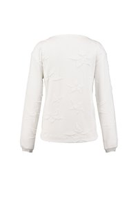 White long-sleeve sweater featuring raised star patterns, textured fabric, rounded neckline, and elastic cuffs.