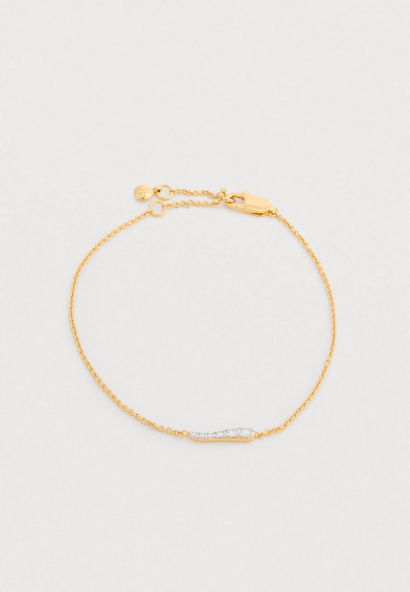 Brățară din lanț aurit cu un centru alungit și elegant, decorat cu cristale mici și clare. Se închide cu o clemă de tip lobster.