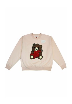 Light pink sweatshirt with a brown teddy bear holding a red heart pierced by an arrow embroidered on the front.