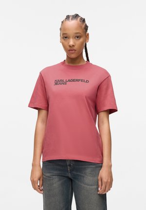 Rød bomull T-skjorte med korte ermer, rund hals og en svart "KARL LAGERFELD JEANS" logo trykt over brystet.