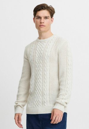 Beige cable-knit sweater featuring textured patterns, ribbed cuffs and hem, round neckline, and a soft, thick material.
