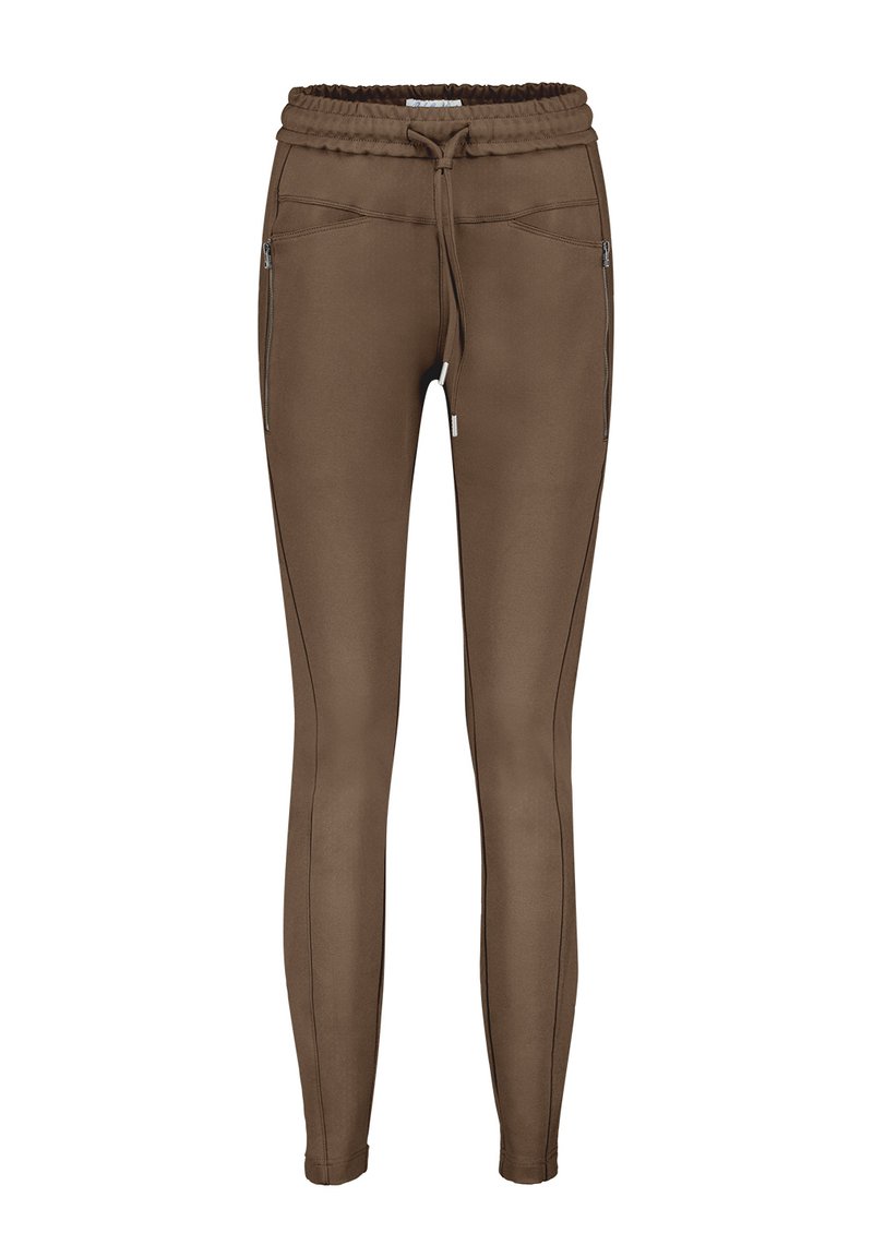 Brune sweatpants lavet af et strækbart materiale, med elastisk talje og snor. Har sidelommer med lynlås og kontrasterende sømdetaljer.