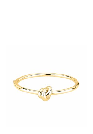 Bracciale rigido in oro con finitura lucida con un motivo centrale decorativo a nodo su sfondo bianco.