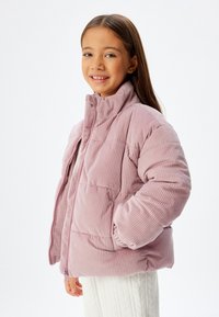 Lilla fløjl pufferjakke med høj krave, lynlås lukning og sidelommer. Fuldforet, med et quiltet design og ribbede manchetter.