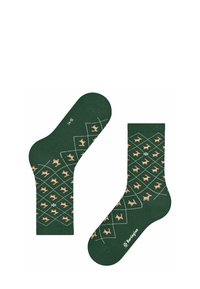 Chaussettes vertes ornées d'un motif avec des formes de cerfs marron clair répétées, entourées de diamants blancs. Fabriquées en textile doux.
