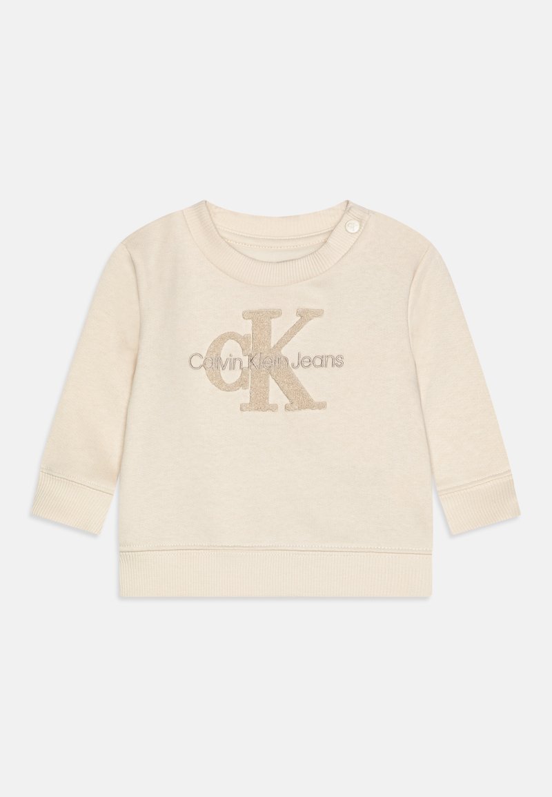 Felpa beige chiaro con maniche lunghe, presenta un collo rotondo e bottoni a pressione. Logo "Calvin Klein Jeans" e "CK" in materiale morbido e in rilievo.