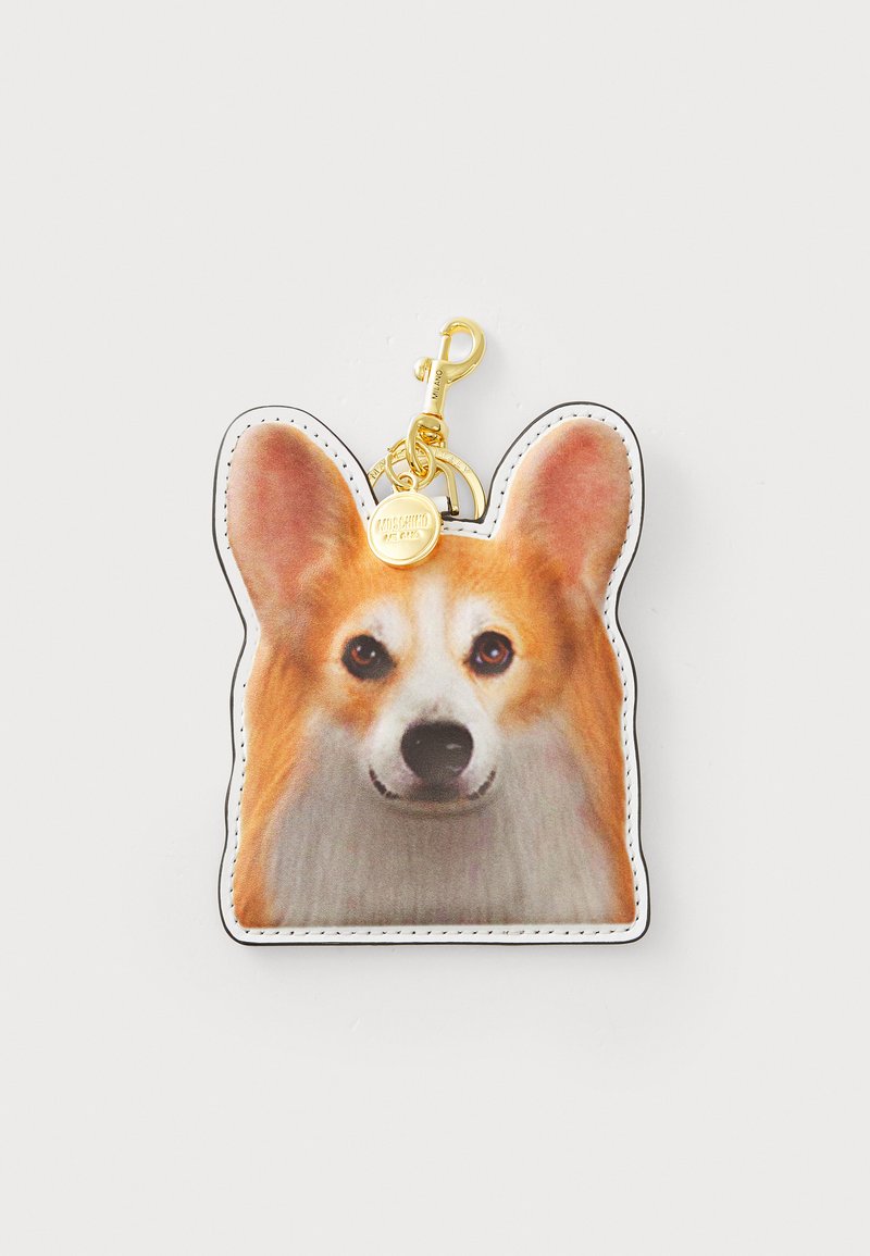 Breloc în formă de Corgi din piele sintetică, cu un design imprimat cu fața unui câine; dispune de accesorii aurii și cusături albe pe margini.