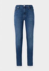 Jean skinny en denim bleu foncé. Caractéristiques : taille haute, poches avant et décoloration subtile. Coupe droite avec surpiqûre à l'ourlet.