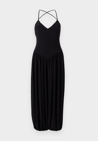 Schwarzes ärmelloses Kleid mit V-Ausschnitt, ausgestattet mit überkreuzten Trägern und einem gerafften, ballonförmigen Rock. Hergestellt aus weichem, leichtem Stoff.