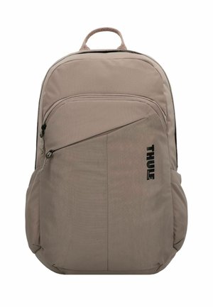 Sac à dos Thule en tissu beige clair, avec une poche zippée à l'avant, des bretelles ajustables et une poignée supérieure pour un transport facile.