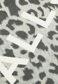 Leopard print fabric in shades of gray, featuring white geometric text accents. The texture appears soft with a slightly woven finish.
