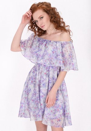 Off-the-shoulder dress made of lightweight, sheer fabric with a floral pattern in pastel purple and pink tones. Flowy silhouette.