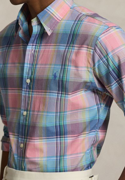 Multicolored plaid shirt featuring pink, blue, and green tones. Made of light fabric with buttoned collar and small logo detail.