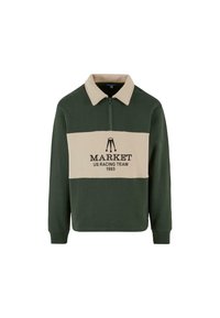 Žalia ir smėlio spalvos ilgomis rankovėmis polo megztinis su užtrauktuku, centre juodu spalva užrašyta "MARKET US RACING TEAM 1993".