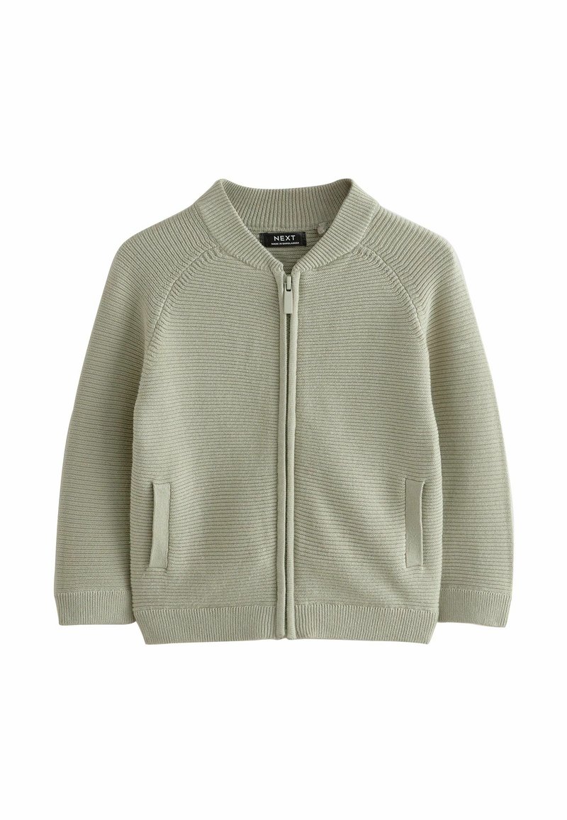 Cardigan zippé en maille vert clair avec col, poignets, ourlet côtelés et deux poches fendues à l’avant, posé à plat sur fond blanc.