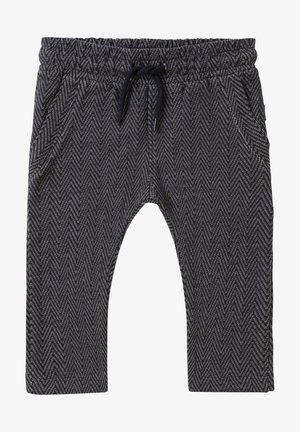 Pantalon à motif chevron noir et blanc avec taille élastique et cordon noir, avec poches latérales et coupe décontractée.