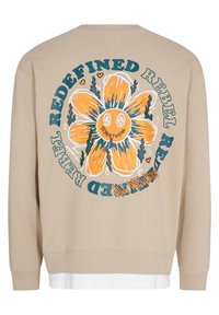 Beige sweatshirt med et stort, farverigt blomstermotiv på ryggen. Har rund halsudskæring, ribbede manchetter og lagdelt hvid kantdetalje.