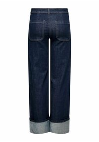 Tumši indigo mazgāti džinsu bikses ar platu, taisnu kāju griezumu. Iezīmētas ar sarullētām piedurknēm gaisākā džinsa krāsā. Divas aizmugures kabatas ar šuvju detaļām.