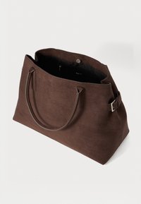 Brown suede tote bag with two handle straps, a snap closure, and an interior zip pocket. Smooth texture with a spacious compartment.
