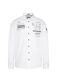 White long-sleeve shirt with a button-up front, featuring black and gray printed text, black buttons, and a classic collar design.