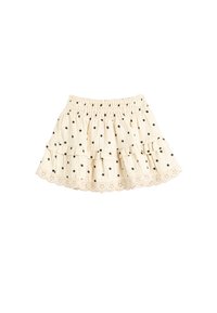 Gonna beige chiaro con pois neri, design a rouches sovrapposte e orlo in pizzo ondulato. Vita elastica per una vestibilità comoda.