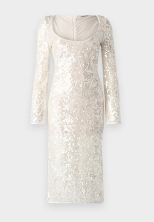 Pitkähihainen, kermahyvä mekko, joka on vuorattu paljeteilla, jossa on kaarrokeleikkaus ja vartalonmyötäinen siluetti. Takana on vetoketjusuljin.