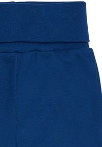 Blaue dehnbare Baumwollleggings mit einem breiten, gerippten Bund. Glatte Textur mit passgenauer Passform und ohne sichtbare Muster oder Hardware.