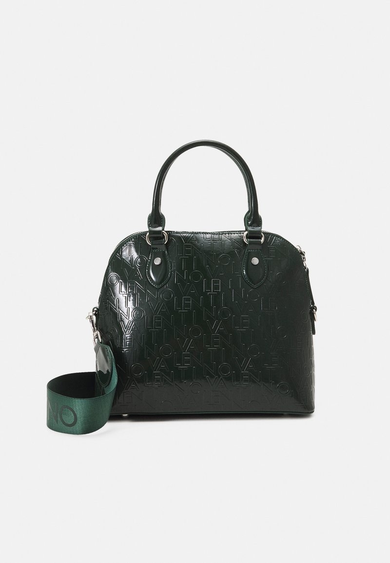 Dark green handbag with an embossed logo pattern, rounded shape, top handles, and an adjustable shoulder strap. Glossy finish with silver hardware.