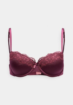 Vīna sarkana krūštura ar mežģīnēm apmalē un veidotiem kausiņiem, regulējamiem satīna lencīšu siksnām un centrālu loku detaļu. Gluda tekstūra un strukturēts dizains.