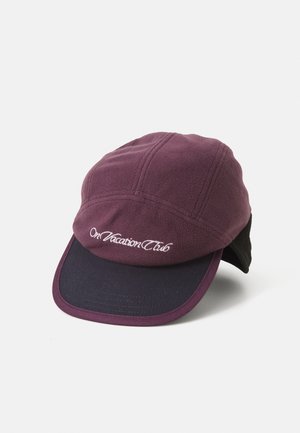 Maroon fleece cap with a dark navy brim. Features stitched details and "On Vacation Club" embroidered on the front. Soft texture.
