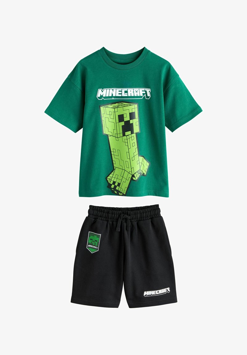 T-shirt vert Minecraft avec un grand motif Creeper et short noir avec logo Minecraft et écusson bouclier Creeper, taille élastique.