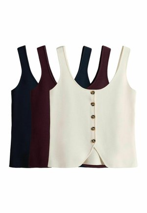 Trois tops sans manches avec boutons sur le devant en bleu marine, bordeaux et crème, disposés en chevauchement sur fond blanc.