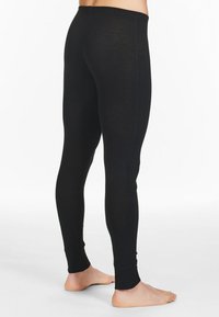 Leggings neri realizzati in un materiale morbido ed elastico. Il design presenta un cintura senza cuciture, una forma aderente e una lunghezza alla caviglia con polsini a coste.