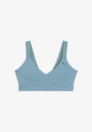 Reggiseno sportivo azzurro chiaro con spalline larghe e un piccolo logo Puma sul lato sinistro, mostrato su uno sfondo bianco.