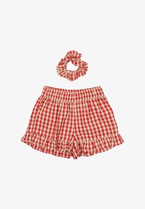 Czerwono-białe szorty w kratkę z falbanką na dole i elastycznym pasem, w komplecie z dopasowaną gumką do włosów. Bawełnowy materiał, casualowy design.