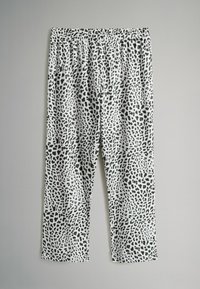 Juodos ir baltos leggingai su viso paviršiaus leopardų raštu, turintys elastingą juosmenį ir laisvą tiesaus kirpimo dizainą.