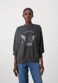 Dark gray sweatshirt with a round neckline, dropped shoulders, and ribbed cuffs. Front graphic features wings and text: "REBELLION" and "MIDNIGHT."
