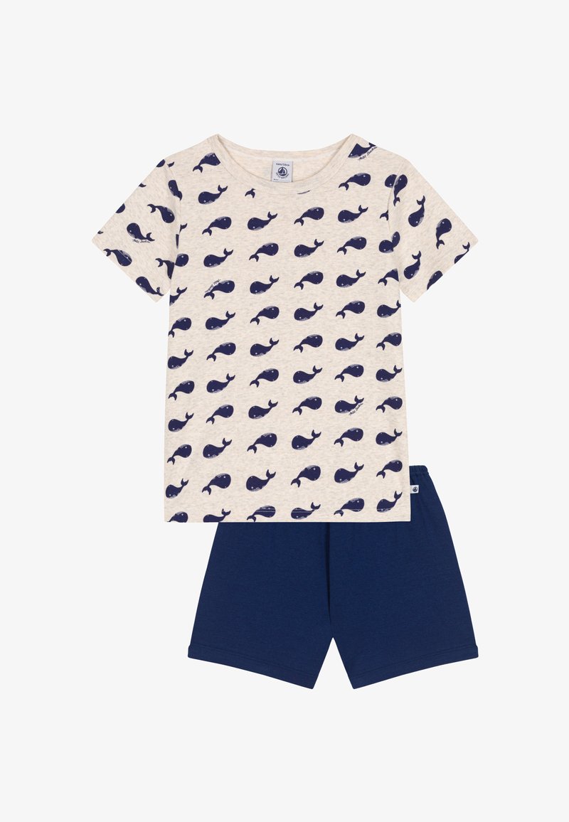 Ensemble deux pièces pour enfants : T-shirt en coton avec imprimé baleine marine sur fond beige, accompagné d'un short uni marine. Manches courtes et col rond.