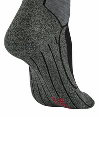 Grau- und schwarze Socke mit strukturiertem Design. Verfügt über vertikale Streifen und ein rotes Logo in der Nähe der Zehen. Das Material scheint gestrickt zu sein, um Langlebigkeit zu gewährleisten.