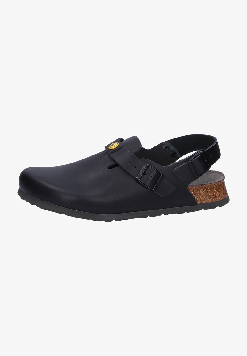 Black closed-toe clog made of rubber with an adjustable strap, textured sole, and cork accent on the heel. Non-slip design.