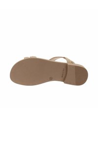 Sandal in colore nude con suola testurizzata, caratterizzata da un design piatto e sottili cinghie. Marchio stampato e taglia 37 sulla suola esterna.