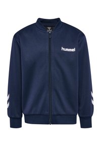 Veste zippée bleu marine avec col, poignets et ourlet côtelés, logo blanc "hummel" sur la poitrine gauche et bandes chevrons blanches sur les manches.