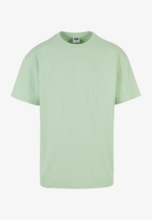 Īsām piedurknēm t-krekls no mīksta, gaiši zaļa kokvilnas. Klasiska apaļa kakla dizains, viegla tekstūra un nedaudz brīvs griezums ērtībai.