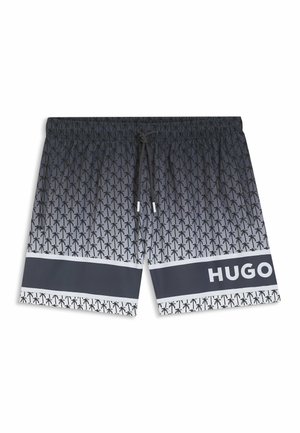 Zwart-witte zwemshorts met een palmboomprint, elastische tailleband, trekkoord en een horizontale zwarte streep met de tekst "HUGO".
