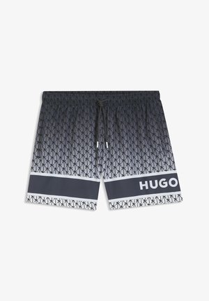 Costume da bagno con sfumatura bianco e nero e motivo a palme, con vita elastica, coulisse e una striscia nera orizzontale con la scritta "HUGO".